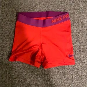 Women’s purple and red Nike pro shorts